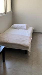 two beds in a room with white sheets at شقة ثلاث غرف ,للعائلات فقط ,Sunrise Sunset1 in King Abdullah Economic City