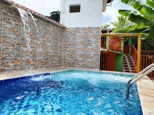 a swimming pool with a water fountain at Casa guadua piscina privada in La Mesa