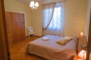 um quarto com uma cama, uma janela e uma cadeira em Poggio Leporaia em Lamporecchio