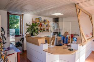 a woman sitting at a counter in a kitchen at Camping Harrobia in Bidart