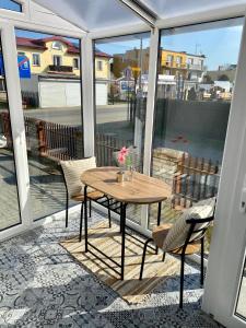a patio with a table and chairs on a balcony at Apartament na Nadmorskiej in Grzybowo