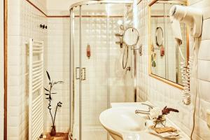 a white bathroom with a sink and a shower at Agriturismo Castello di Spedaletto in Pienza +33 photos