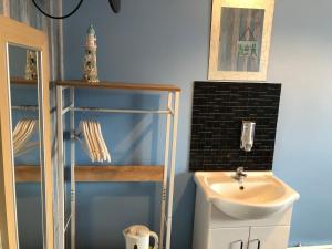 a bathroom with a sink and a toilet at The Franklyn Hotel B&B in Blackpool +44 photos