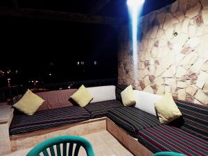 a couch sitting on a balcony at night at Marina Wadi Degla villa duplex 4 Rooms Ain Sokhna in Ain Sokhna