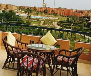 a table and chairs on a balcony with a view at Marina wadi degla villa duplex Ain Sokhna in Ain Sokhna