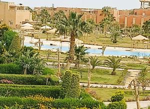 a view of a resort with palm trees and bushes at Marina wadi degla villa duplex Ain Sokhna in Ain Sokhna
