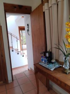 a room with a table with a coffee maker on it at Casa d'Lobo Hotel Boutique in Malinalco