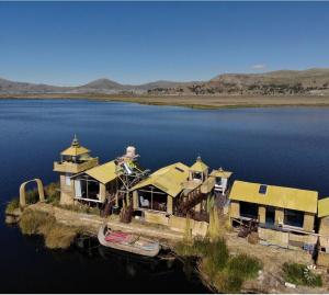 an aerial view of a house in the middle of a lake at Amalia Titicaca Lodge in Puno
