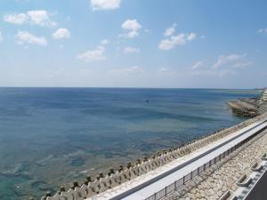 a view of the ocean from the balcony of a resort at Lagoon Palace in Nogunukaniku