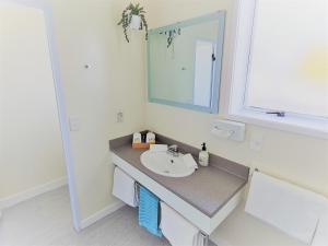 a bathroom with a sink and a mirror at Kings Court Motel in Whanganui