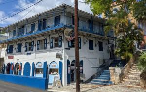 a blue and white building with a blue balcony at The Landmark St Thomas 3BR Apt in Fort Christian