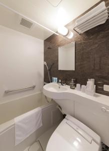 a bathroom with a white toilet and a sink at Five Hotel Osaka in Osaka