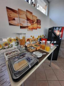a kitchen with a table with food and drinks on it at Villa Mayoti B&B in Manerba del Garda