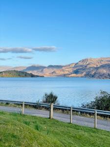 a view of a lake with mountains in the background at Loch Morar Private Suite in Mallaig