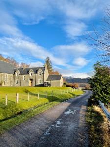a house on the side of a road at Loch Morar Private Suite in Mallaig