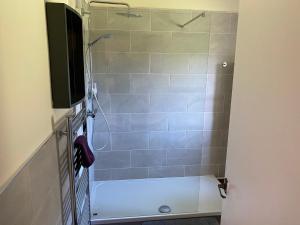 a bathroom with a shower with a bath tub at Loch Morar Private Suite in Mallaig