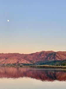 a view of a lake with mountains in the background at Loch Morar Private Suite in Mallaig