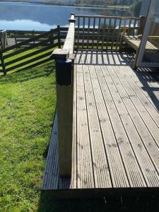 a wooden deck with a trash can on top of it at Loch Morar Private Suite in Mallaig