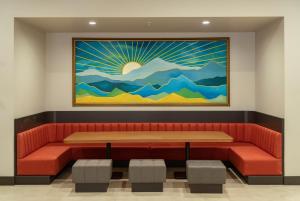 a waiting room with a red bench and a painting on the wall at Sundia Exclusive By Liberty Fethiye Adults Only in Fethiye