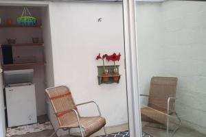 two chairs sitting on a porch with a mirror at La maison de Louise in Fontenay-le-Comte