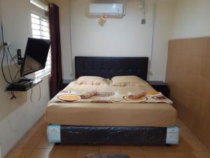 Postel nebo postele na pokoji v ubytování GIO Guesthouse Bogor