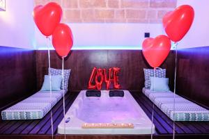 a hot tub with two red heart balloons at Cuorcuoredicasa in Monopoli