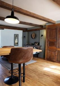 a dining room with a table and a bedroom at La ruelle in Durbuy