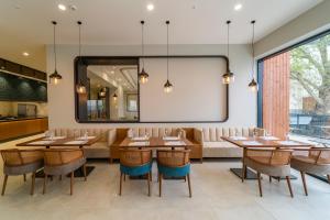 a restaurant with tables and chairs and a large mirror at Sundia Exclusive By Liberty Fethiye Adults Only in Fethiye