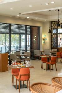 a restaurant with tables and chairs and windows at Sundia Exclusive By Liberty Fethiye Adults Only in Fethiye