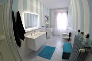 a white bathroom with a sink and a toilet at CASA DI MIRCO - AMPIO E MODERNO BILOCALE in Castenedolo