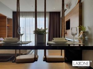 a dining room with two glasses and a table at Aeropod Sovo Studio - Laxzone Suite in Kota Kinabalu