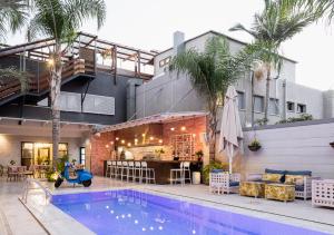 a swimming pool in front of a building at Estate Spa Boutique Hotel - Adults Only in Rechovot