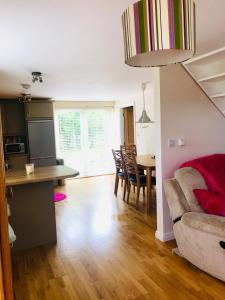 a kitchen and living room with a table and a couch at Red Deer Cosy Apartment in Letterfrack Connemara in Letterfrack