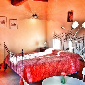 a bedroom with a bed and a table in it at Agriturismo Ca' Bertu' in Zappolino