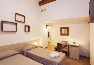 a hotel room with two beds and a desk and a desk at Casa Porta Marina in Ventimiglia
