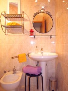 a bathroom with a sink and a mirror at Apartments Dani želja in Makarska