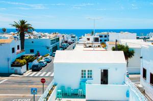 an aerial view of a city with buildings and the ocean at Turquesa Beach&Pool Apartaments in Playa Honda