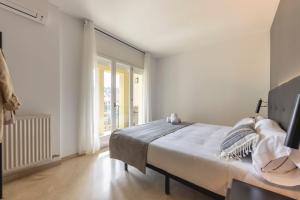 una camera bianca con un letto e una finestra di Bravissimo Plaça de la Independència, Morning Sun a Girona