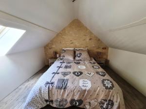 a bedroom with a bed in a attic at Le Petit Logis in Bléré