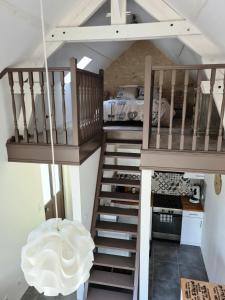 a room with a staircase leading to a bedroom at Le Petit Logis in Bléré