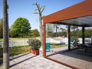a screened in porch with a view of a yard at Villa Roma Holidays in Jesolo