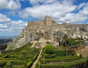 a castle on top of a mountain with a garden at Al-Andalus Alojamentos in Marvão +31 photos