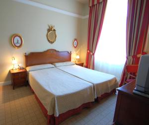 Säng eller sängar i ett rum på Arcea Gran Hotel Pelayo