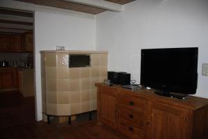 a television sitting on top of a wooden dresser at Schleikate in Winnemark