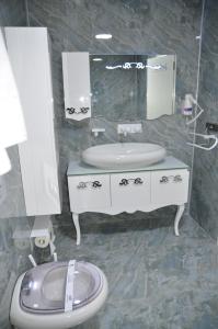 a bathroom with a sink and a toilet and a mirror at Grand Hotel Van in Van +22 photos
