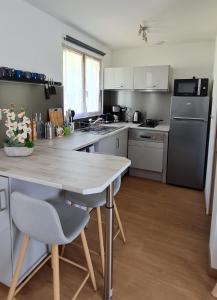 a kitchen with a table and a counter top at La Cabane de Fierville in Fierville-les-Parcs
