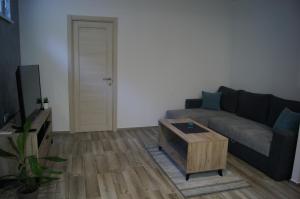 a living room with a couch and a coffee table at Apartman Una in Sremski Karlovci