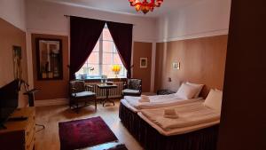 a bedroom with a bed and a table and a window at Leopold Boutique Hotel in Östersund