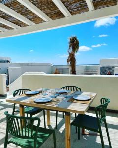 a table and chairs on a patio with a view at Le Casuzze Ammare in Favignana