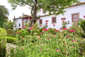 Quinta da Maínha - Charming Houses في براغا: حديقة امام بيت ابيض ورد وردي